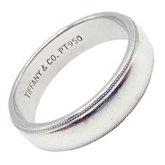 a wedding ring with the words tiffany & co pt950 on it