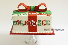 the cake is decorated with red, green and white ribbon