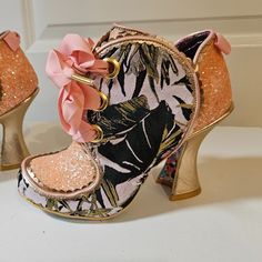 Brand New, Nwot Never Been Worn Irregular Choice Floral And Glitter Bootie. Peach And Floral Print Metallic Details Lace Up Bootie With Pink Ribbon Laces Sitting On A Gold Curved Heel. Super Cute Bootie In Excellent Condition. Enjoy! Pink Sequined Round Toe Heels, Spring Boots With Glitter Accents And Round Toe, Pink Glitter High Heel Boots, Spring Pink Glitter Heels, Pink Low Heel Party Boots, Pink Low Heel Boots For Party, Pink Glitter Accents Round Toe Boots, Pink Glitter Accented Round Toe Boots, Masks Ideas