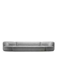 a gray couch sitting on top of a white floor