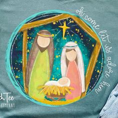 a t - shirt with the nativity scene painted on it