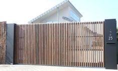 a large wooden fence next to a building with a number twenty on it's side