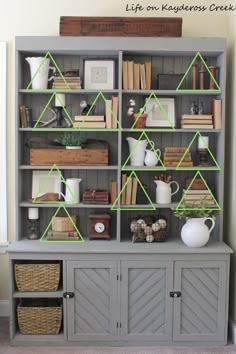 an old bookcase has been decorated with green tape to decorate shelves for books and other things