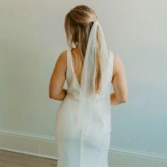 the back of a woman wearing a wedding veil