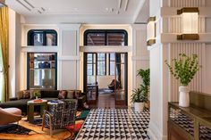 a living room filled with furniture and lots of windows