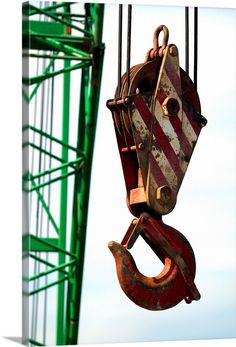 an old crane is being lifted by a crane hook