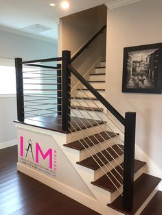 there is a stair case in the middle of this room with wood floors and white walls