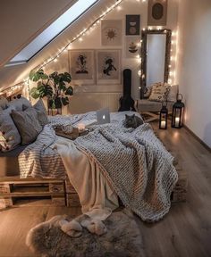 an attic bedroom decorated in white with string lights