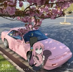 a pink car parked on the side of a road next to a cherry blossom tree