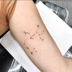 a woman's arm with small stars on it