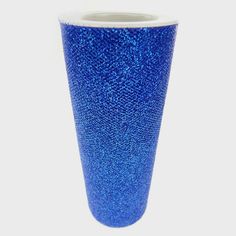 a blue vase sitting on top of a white table