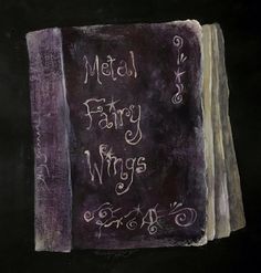 a book with writing on it that says metal fairy wings