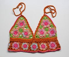 Handmade crochet top special edition unique design orange floral Anni & Amie Available in UK 10 to buy now. See below on how to preorder if you would like a different size: We're a UK brand that specialise in handmade clothing. All our items are created by Anne Lee, with help from Amy. Our styles reflect hippie/bohemian fashion and we like to mix bright colours and patterns to create one of a kind items.  Every item is slightly different and unique, all handmade personally for you with love. This means we only sell in limited quantities and not every size/style is listed. If you are interested in an item and would like to pre-order this in your size, please send us a message. Please check out our other items x Spring Fitted Orange Crochet Top, Fitted Orange Crochet Top For Spring, Spring Orange Fitted Crochet Top, Spring Crochet Orange Tops, Sleeveless Granny Square Tops For Spring, Sleeveless Orange Crochet Top For Spring, Fitted Orange Crochet Top For Summer, Fitted Orange Crochet Top For Vacation, Handmade Multicolor Tops For Spring