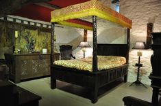 a canopy bed sitting in the middle of a room