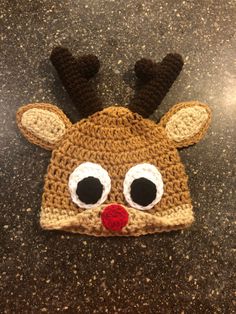 a crocheted reindeer hat with big eyes