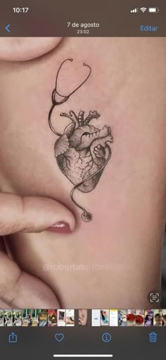 a woman's stomach with a heart tattoo on it