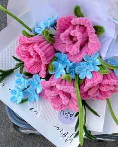 pink and blue flowers sitting on top of each other