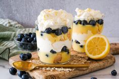 two desserts with blueberries and lemon on a cutting board