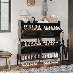 there is a shoe rack in the room with many pairs of shoes on top of it