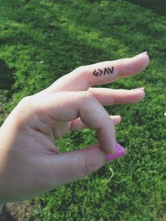 a person's hand with the word vk on it and an arrow tattoo