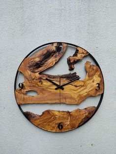 a clock made out of wood on the side of a building