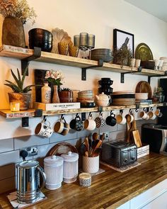 the kitchen counter has many pots and pans on it