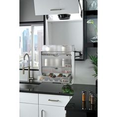 a kitchen with white cabinets and black counter tops