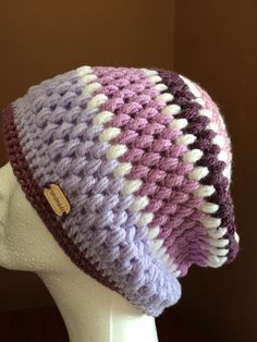 a crocheted hat on top of a mannequin head