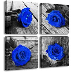 three blue roses sitting on top of a wooden table next to each other in black and white