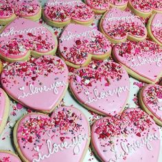 heart shaped cookies with pink frosting and sprinkles