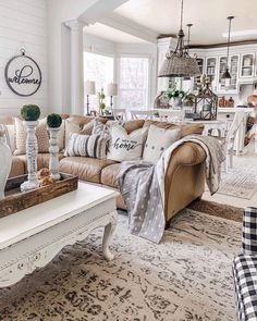 a living room filled with lots of furniture and decor on top of a white rug