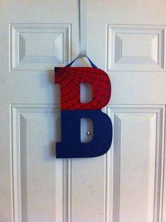 a door hanger with the letter b on it's side and a spiderman logo