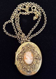 "Vintage Danecraft 12K Gold Filled Oval Cameo Locket. The top face of the locket has a hand engraved design with an applied filigree design framing the hand carved cameo. The necklace bail has a matching filigree design. Chain and Locket Marked: Danecraft 12k GF Locket measures approximately 2\" x 1.5\" Chain measures approximately 24\" long VERY GOOD USED CONDITION WITH MINIMAL WEAR FROM AGE AND USE PLEASE VIEW ALL PHOTOS AND ASK ANY QUESTIONS BEFORE PURCHASING!" Luxury Heirloom Oval Necklace, Gold Medallion Locket Necklace With Filigree, Heirloom Jewelry With Intricate Design For Collectors, Luxury Engraved Oval Cabochon Jewelry, Elegant Antique Gold Locket Necklace For Formal Occasions, Elegant Antique Gold Locket Necklace For Formal Events, Cameo Medallion Jewelry For Gifts, Ornate Medallion Locket Necklace With Intricate Design, Luxury Antique Gold Collectible Jewelry