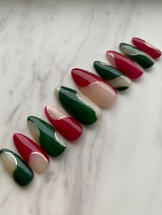 Set of 10 hand painted press on nails in an abstract swirl pattern. Christmas Press on Nail set. Contains slightly translucent nails with red and green abstract swirling lined with gold. Set shown is in the medium stiletto shape. Glossy finish will be the default, please let me know if you would prefer a matte finish. Please message me if you have any questions. *All orders come with one application/prep kit. Orders with 4+ sets will come with 2 application kits. Each kit comes with: Nail glue, cuticle pusher, 2x alcohol prep pads, and a mini nail file. Alternatively, nail tabs can be requested instead of the nail glue, just leave me a note. Additional prep kits can be purchased as well, see accessories section to view listings.  **Since all sets are custom made to order, there will be sli Red Green And Gold Nails Christmas, Red And Green Nail Art, Red Green Gold Nails, Red White And Green Nails, Abstract Christmas Nails, Peppermint Swirl Nails, Retro Christmas Nails, Alternative Christmas Nails, Green And Red Nails