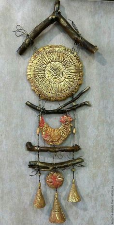 a wall hanging made out of different types of metal items and wood sticks with birds on them