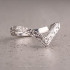 a silver ring with intricate designs on it