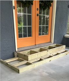 a couple of wooden pallets sitting on top of a cement floor next to a door