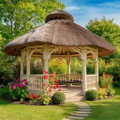 a gazebo surrounded by flowers and greenery