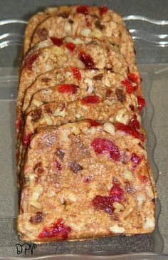 there are four slices of fruit cake in the plastic container on the table, ready to be eaten