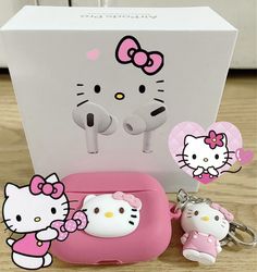 hello kitty keychain and other items are on the floor next to a box