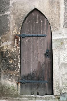 an old wooden door with iron bars on it