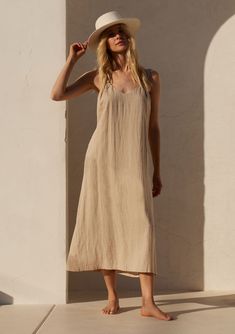 There's a reason we're obsessed with this effortless mid-length dress in a linen-cotton blend. It's the perfect mix of cool with its easy, loose fit, but still has sexy elements like the ultra-low back. With thick tank top straps and essential side pockets, this is one style you'll be reaching for all Summer long. Linen blend Relaxed fit Sleeveless Thick tank top straps Mid-length V-neckline Low back Side pockets Try the straps crossed Easy Summer dress Wheat colorway is lined Model is 5'8, wear Mid Size Resort Wear, Thick Tank Top, Loose Summer Dress, Simple Summer Dresses, Resort 2024, Top Straps, Bohemian Dresses, Long Vest, Tank Top Straps