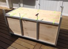 an unfinished kitchen cabinet sitting on top of a wooden deck