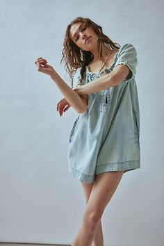 The perfect denim instant outfit with a breezy feel, this sweet romper from our We The Free collection will be your go-to all season long. **Fit:** Relaxed, babydoll-inspired fit throughout **Features:** Wide neckline that can be worn off-the-shoulder, front keyhole feature, frayed detailing, side pockets **Why We ❤ It:** Bold with tall boots or off-duty with sporty sneakers, this style has endless ways to wear. | We The Free Daisy Denim Babydoll Romper at Free People in Light Wash, Size: M Babydoll Romper, Glitter Shorts, Denim Playsuit, Perfect Denim, Sporty Sneakers, Style Finder, Doll Ideas, Blue Fits, Chambray Dress