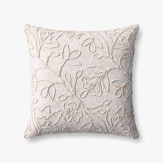 a white pillow with an embroidered design on the front and back, it is made from linen