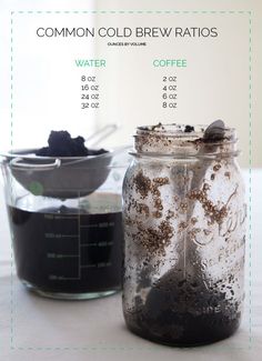 two jars filled with liquid sitting on top of a white table next to each other