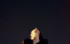 a woman looking up at the stars in the sky