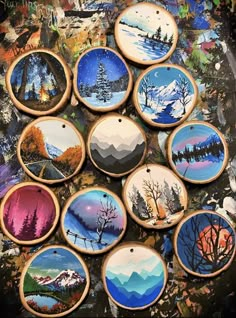 a bunch of painted wooden ornaments sitting on top of a table