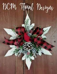 a red and black christmas wreath with pine cones