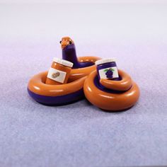 an orange and purple inflatable boat with a bottle on the top is laying on the floor